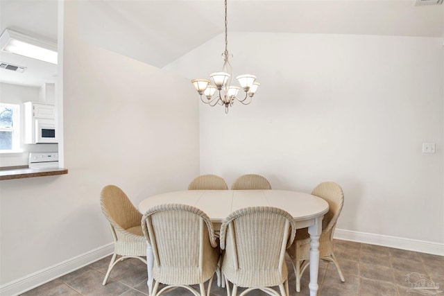 dining space featuring lofted ceiling and a notable chandelier