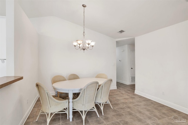 dining room featuring vaulted ceiling and a notable chandelier