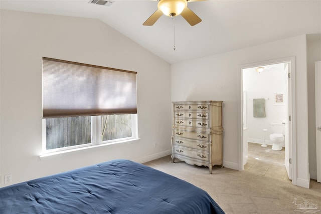 carpeted bedroom featuring vaulted ceiling, ceiling fan, and ensuite bathroom