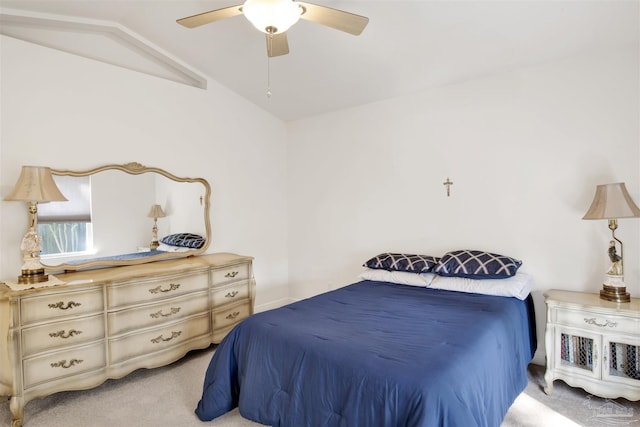 carpeted bedroom featuring vaulted ceiling and ceiling fan