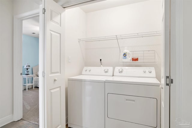 washroom with washing machine and dryer and light colored carpet