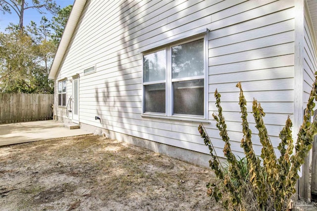 view of property exterior with a patio area