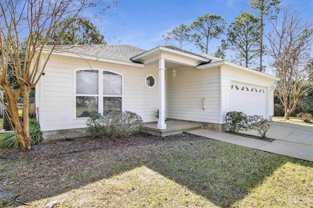 ranch-style house with a garage and a front yard