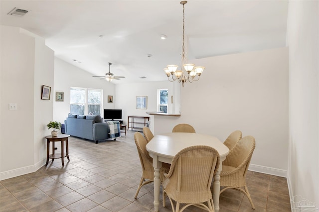 dining room featuring lofted ceiling, ceiling fan with notable chandelier, and tile patterned floors