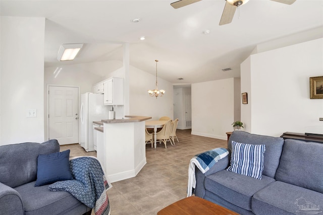 living room featuring ceiling fan with notable chandelier and vaulted ceiling