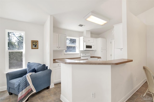 kitchen with white cabinets, white appliances, and kitchen peninsula