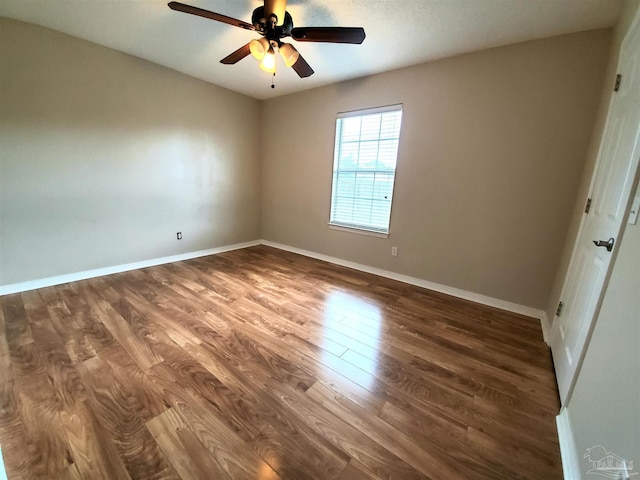 spare room with hardwood / wood-style floors and ceiling fan