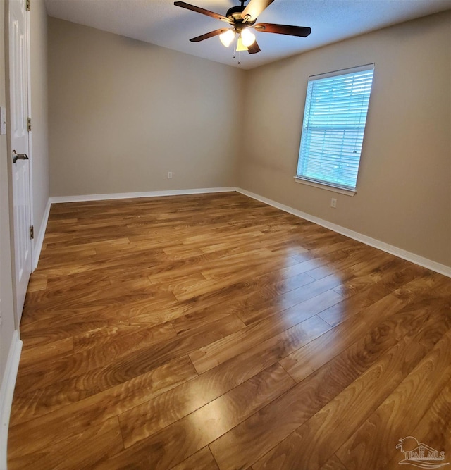 empty room featuring hardwood / wood-style flooring and ceiling fan