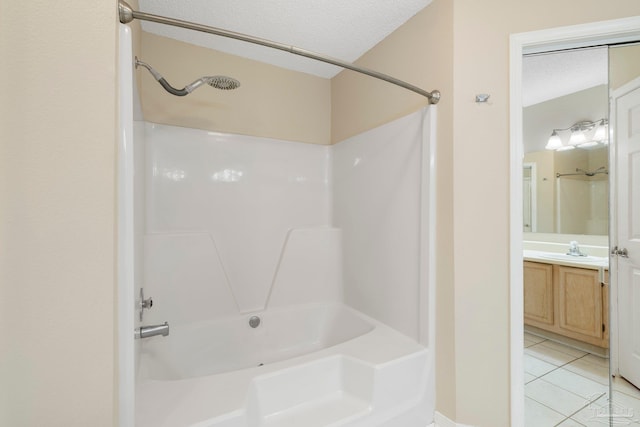 bathroom featuring tile patterned flooring, vanity, a textured ceiling, and shower / bathing tub combination