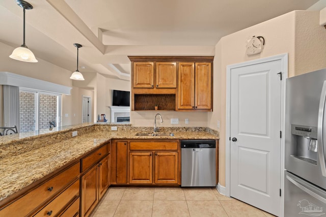 kitchen featuring pendant lighting, sink, light stone countertops, appliances with stainless steel finishes, and light tile patterned flooring