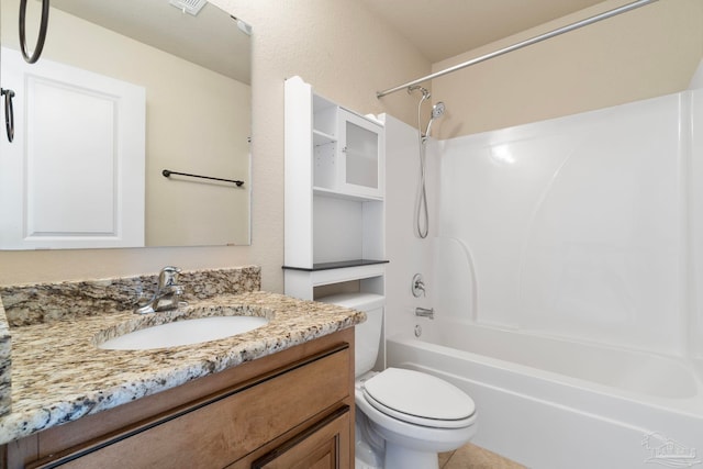 full bathroom featuring washtub / shower combination, vanity, and toilet