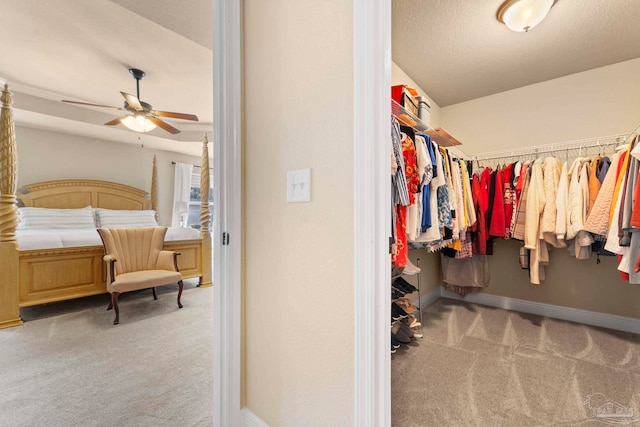 walk in closet featuring ceiling fan and light colored carpet