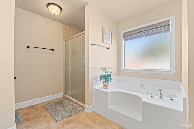 bathroom with tile patterned flooring and independent shower and bath