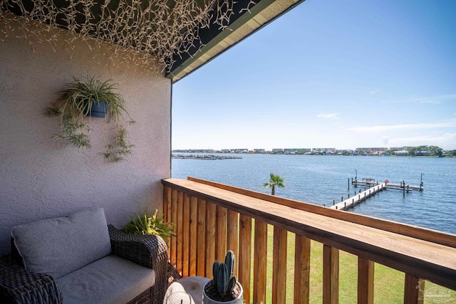 balcony with a water view and a boat dock