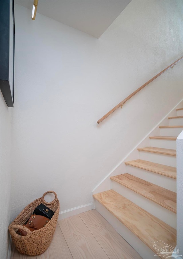 stairway featuring wood-type flooring