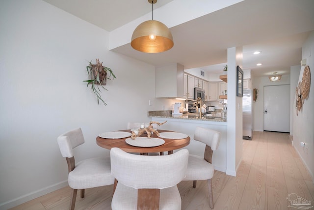 dining space featuring light hardwood / wood-style flooring