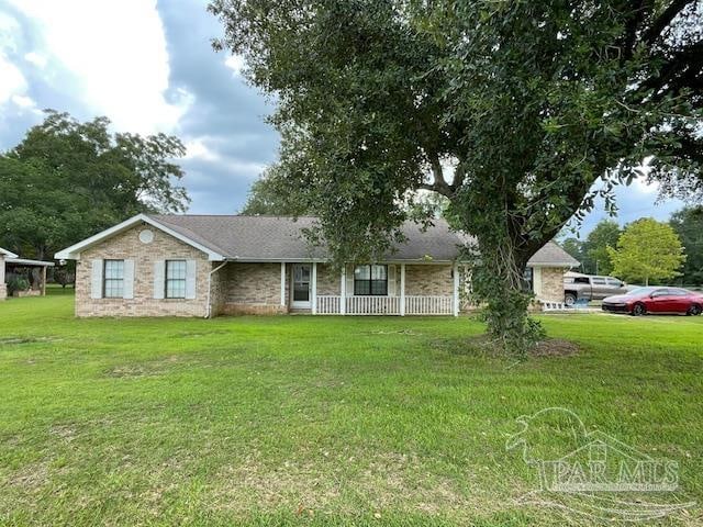 ranch-style home with a front yard