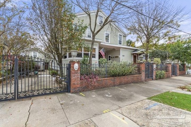 view of front of house with a fenced front yard and a gate