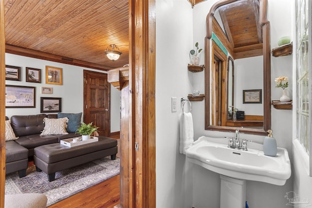 bathroom featuring wood ceiling and a sink