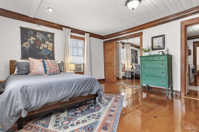 bedroom with ornamental molding, cooling unit, wood finished floors, and wood ceiling