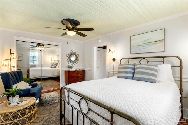 bedroom featuring wooden ceiling, ceiling fan, wood finished floors, crown molding, and a closet