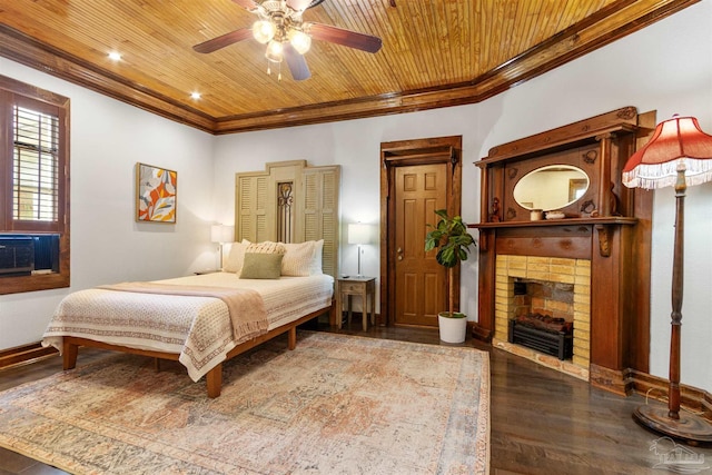 bedroom featuring a fireplace, crown molding, wood ceiling, wood finished floors, and baseboards