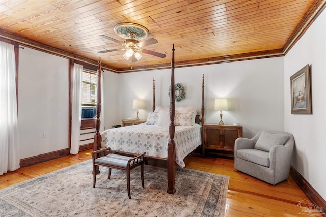 bedroom featuring wooden ceiling, crown molding, baseboards, and wood finished floors