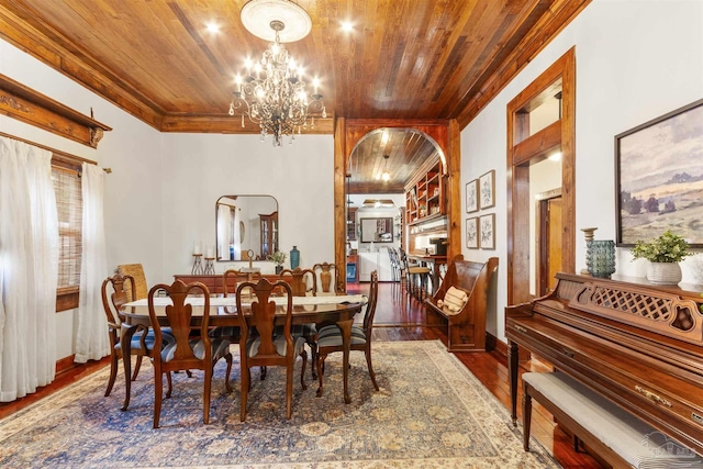 dining room featuring arched walkways, wood finished floors, wood ceiling, an inviting chandelier, and crown molding