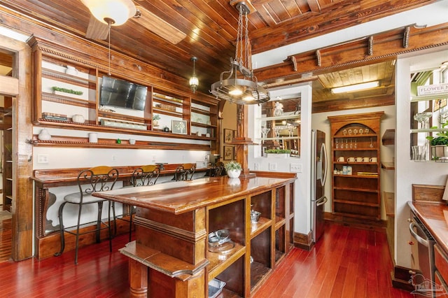 bar with wood ceiling, baseboards, hanging light fixtures, freestanding refrigerator, and dark wood finished floors