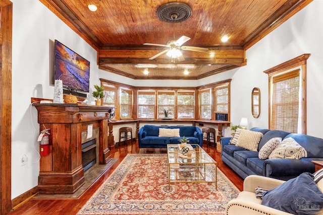 living room featuring a glass covered fireplace, wooden ceiling, crown molding, and wood finished floors