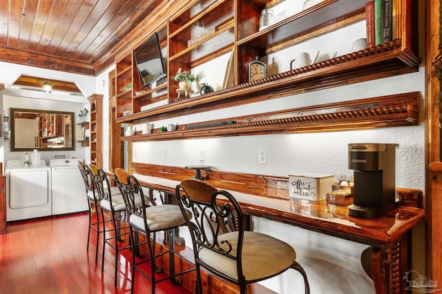 bar featuring wooden ceiling, wood finished floors, independent washer and dryer, crown molding, and ornate columns