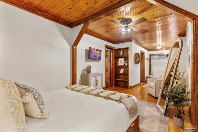 bedroom featuring ornamental molding, light wood-type flooring, and wood ceiling