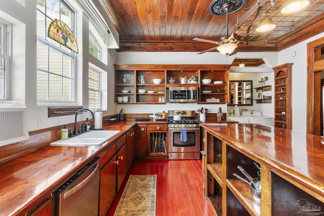 kitchen featuring wooden ceiling, appliances with stainless steel finishes, ornamental molding, separate washer and dryer, and a sink