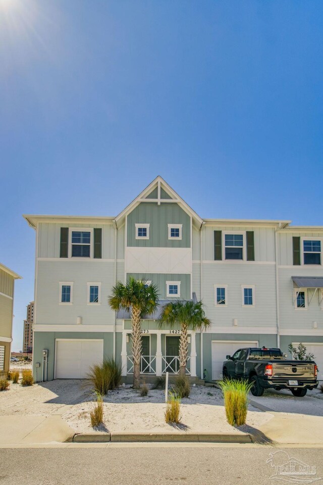 14273 Beach Heather Ct, Pensacola, FL 32507 - townhome / multi-family property featuring a garage, board and batten siding, and driveway