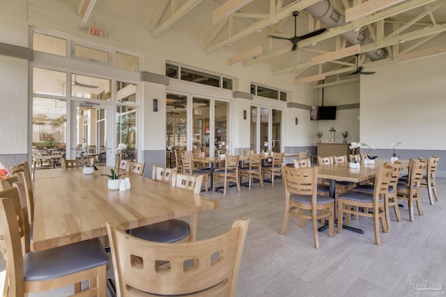 14273 Beach Heather Ct, Pensacola, FL 32507 - dining space with beam ceiling, high vaulted ceiling, a ceiling fan, wood finished floors, and french doors
