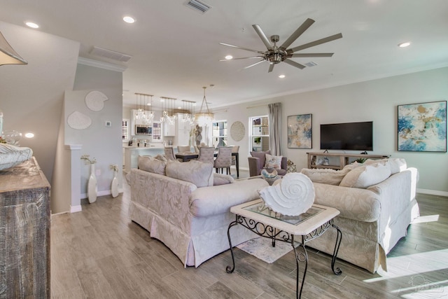 14273 Beach Heather Ct, Pensacola, FL 32507 - living area with wood finished floors, a ceiling fan, visible vents, and ornamental molding