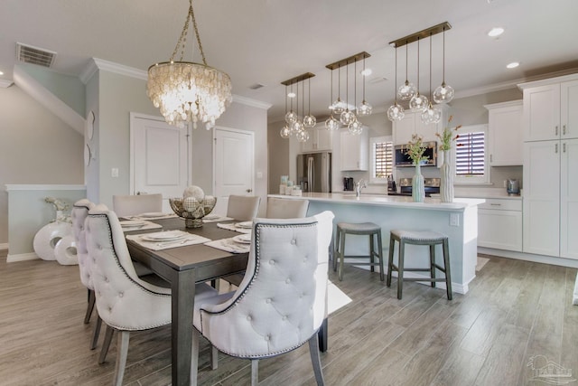 14273 Beach Heather Ct, Pensacola, FL 32507 - dining room with visible vents, recessed lighting, crown molding, light wood finished floors, and a chandelier