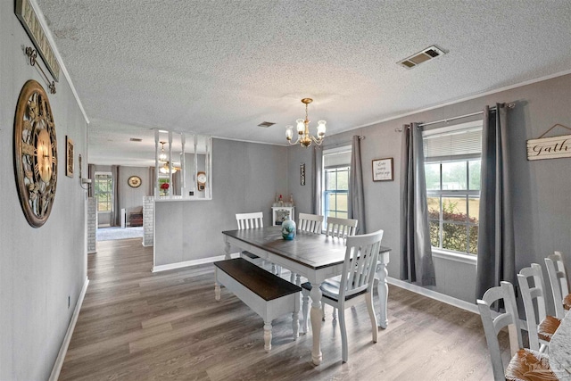 dining room with a textured ceiling and wood-type flooring