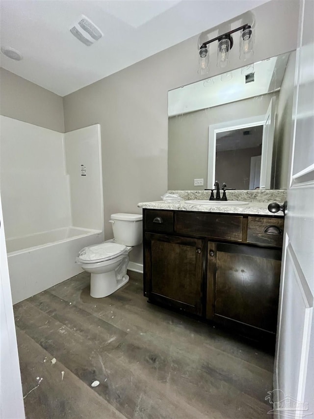 full bathroom featuring vanity, toilet, and  shower combination