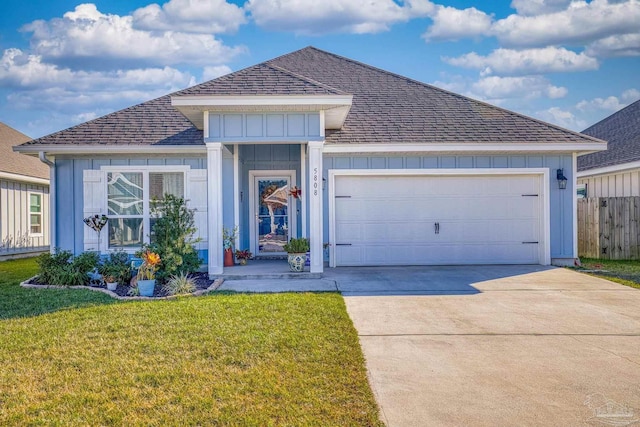 view of front of home with a garage and a front lawn