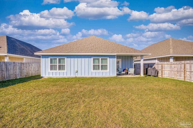 rear view of house featuring a patio and a yard