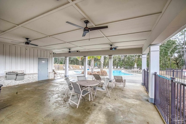 view of patio / terrace featuring a fenced in pool and ceiling fan