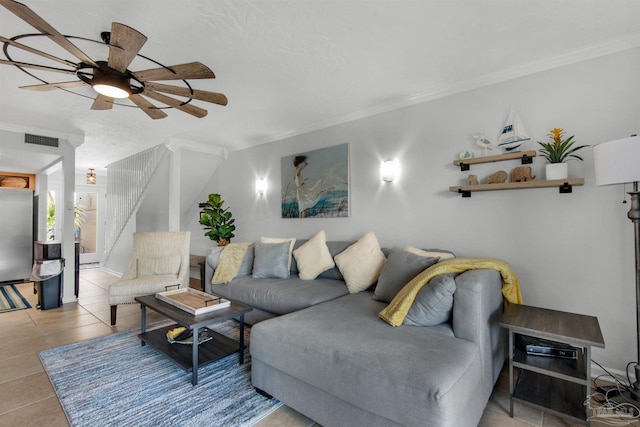 tiled living room featuring ceiling fan and crown molding