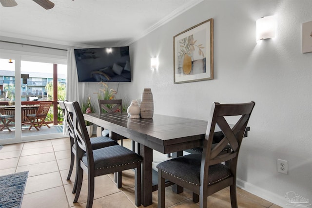 dining space with light tile patterned floors, ornamental molding, and ceiling fan