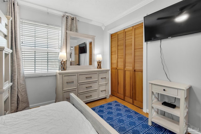 bedroom with a closet and crown molding