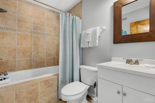 full bathroom featuring toilet, vanity, and shower / bathtub combination with curtain