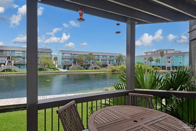 wooden terrace featuring a water view