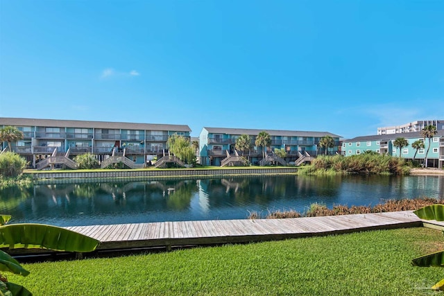 view of community featuring a water view and a yard