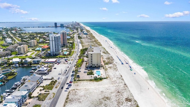 drone / aerial view featuring a beach view and a water view