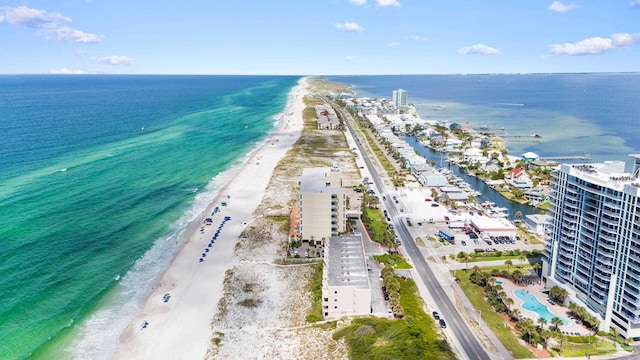 birds eye view of property featuring a beach view and a water view